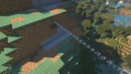 A very basic zipline design dug into the side of a large hillside (Image via Mojang).